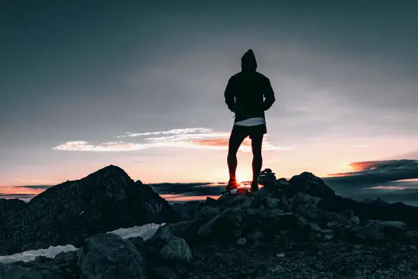 hiker moving toward sunrise